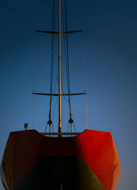 A red sailing boat with a blue background