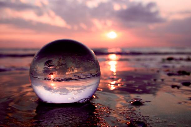istock Crystal ball on beach during sunrise 1500914617