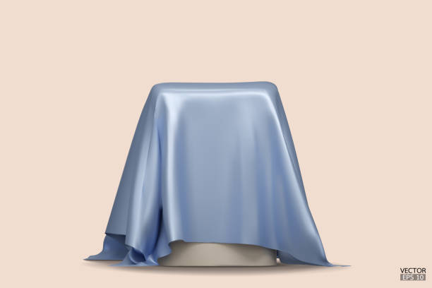 istock Podium covered with a piece of blue silk isolated on beige background. Realistic box covered with blue cloth. Podium for product, cosmetic presentation. Creative mock up. 3d vector illustration. 1500915756