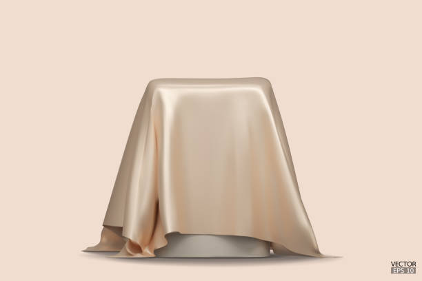 istock Podium covered with a piece of gold silk isolated on beige background. Realistic box covered with beige cloth. Podium for product, cosmetic presentation. Creative mock up. 3d vector illustration. 1500915855