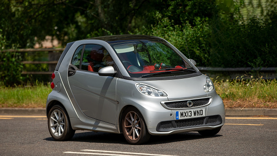 Milton Keynes,UK - June 23rd 2023:  2013 silver SMART FORTWO PASSION MHD AUTO car travelling on an English road