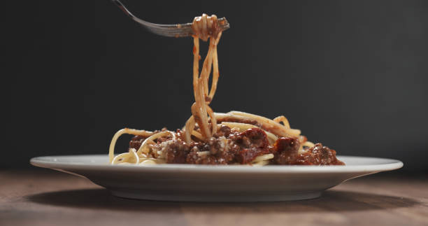 istock eating spaghetti with bolognese sauce with fork 1500916238