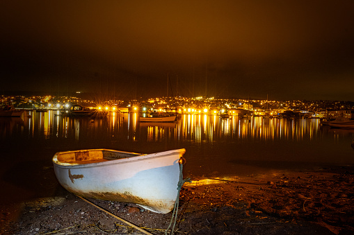 Tethered boat on beach at night in Devon