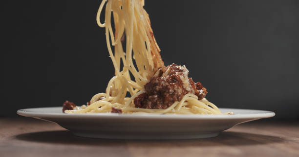 istock eating spaghetti with bolognese sauce with fork 1500916318