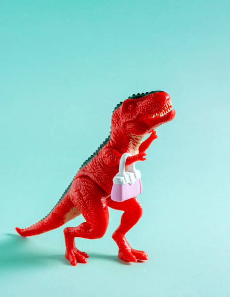 Plastic mass produced toy dinosaurs attacking technology. This a concept image for 'Don't Be A Dinosaur' or a Luddite theme.