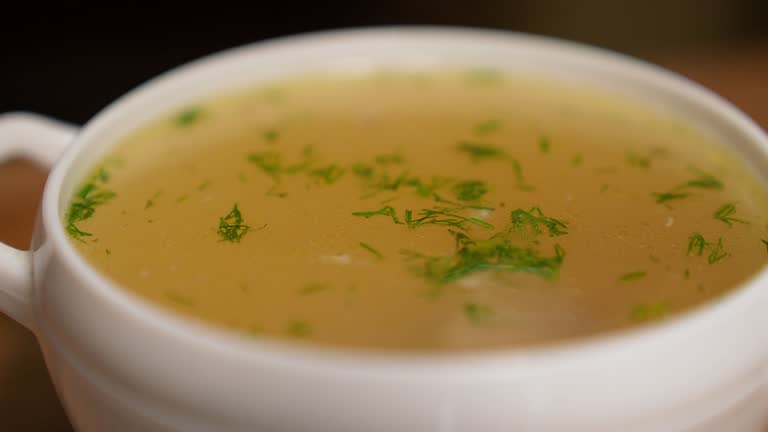 Macro view: The chicken bouillon with noodles, dill and chicken meat