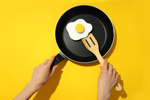 istock Concept of cooking on yellow background, fried egg 1500920922