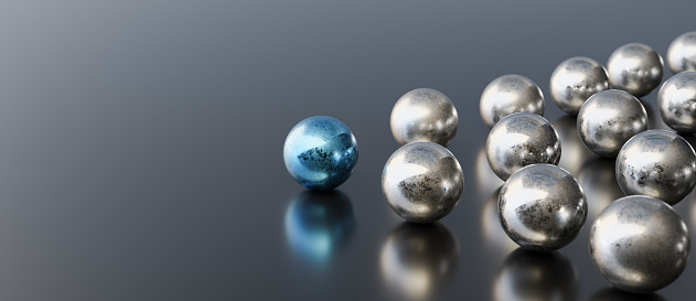 Leadership concept, blue leader ball leading silver balls, on black background with empty copy space on left side. 3D Rendering