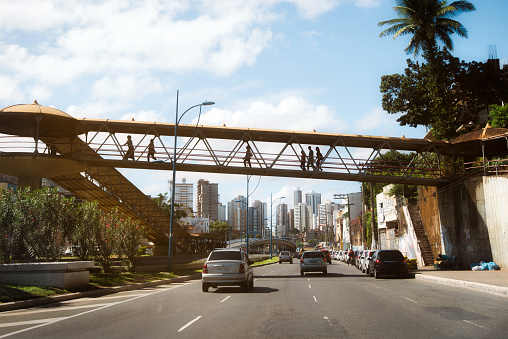 modern skyline behind footbridge crossing big road in the City of Salvador da Bahia