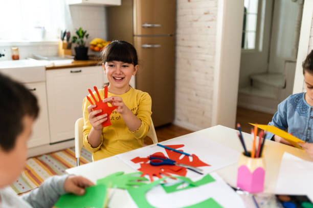 istock Creative children doing crafting with colorful paper at home 1500929496