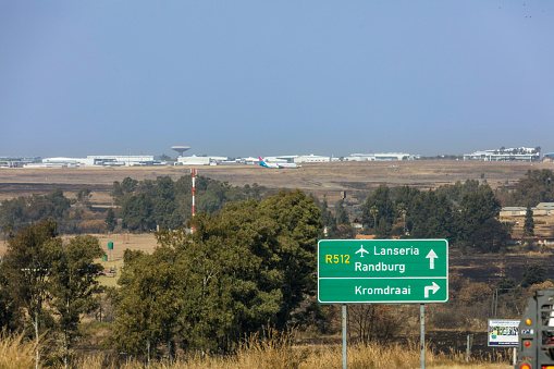 Lanseria airport in Johannesburg, South Africa with  a aeroplan seen on the runway on the hillside.