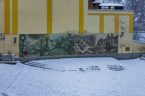 Klodzko, Poland - January 2023: Big and old banner on wall of building with printed famous places in Klodzko city in retro look