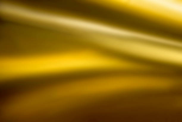 Abstract blurred background with golden highlights with grainy noise effect, Gradient background for product presentation. Smooth transitions of iridescent colors.
