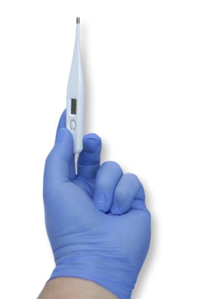 istock Thermometer in a person's hand with a multicolored background. 1500942245