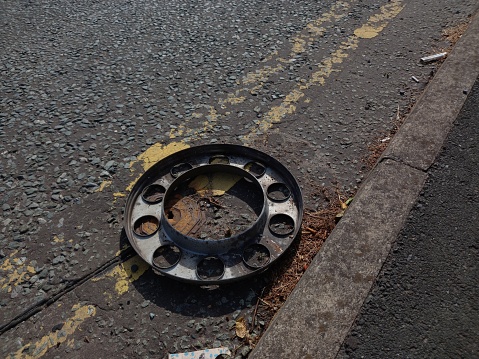 Lying amongst the double yellow lines is a wheel which it's vehicle was involved in a road traffic accident.