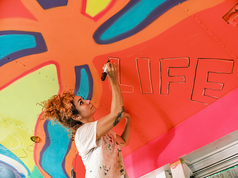 Naberezhnye Chelny, Russia - May 20, 2023 : Festival of street graphics-graffiti, young people, guys and girls, draw on the walls with paints