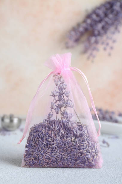 istock Scented sachet with dried lavender flowers on light gray table 1500946521