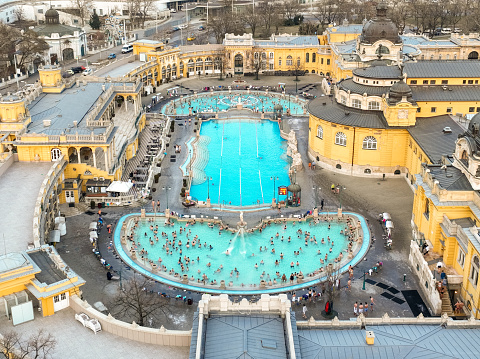 Budapest, Hungary - February 10, 2023: Thermal Bath Szechenyi in Budapest, Hungary. People in Water Pool. Drone Point of View.