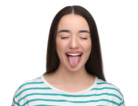Happy woman showing her tongue on white background