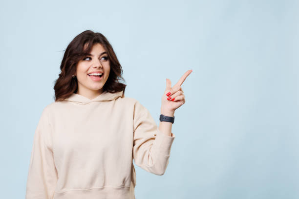 istock Gen Z Blogger Pointing to Copy Space in Studio 1500950860