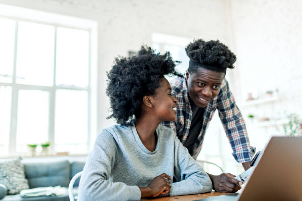 istock Two college students using laptop for studying together at college dorm 1500953363