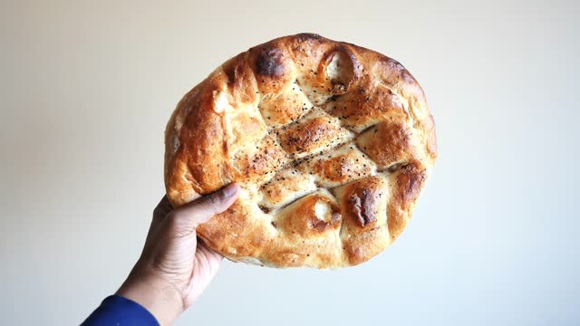 POV shot of holding a Ramadan Pide, Turkish popular bread,