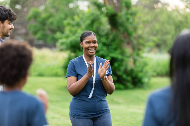 istock Mature female volunteer coordinator congratulates her team 1500955784