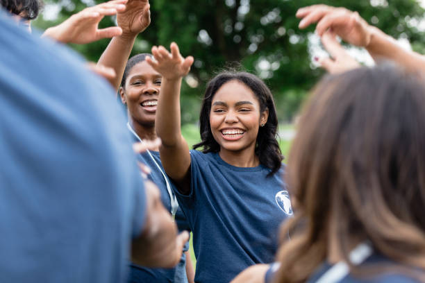 istock Before starting work, volunteers raise arms in cheer of unity 1500955791