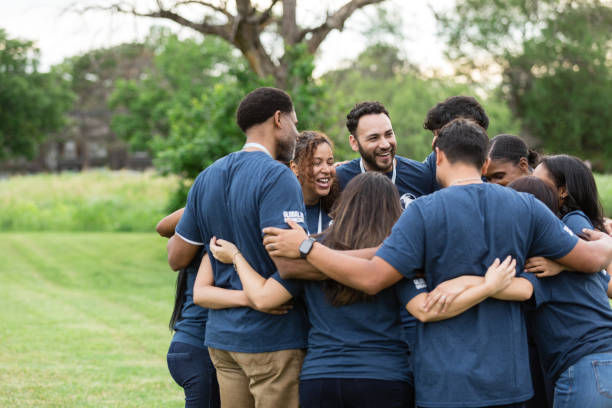 istock Diverse volunteer group laughs and jokes standing in circle 1500955820