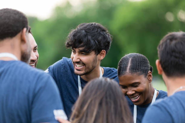 istock Diverse volunteers smile and talk together in huddle 1500955829