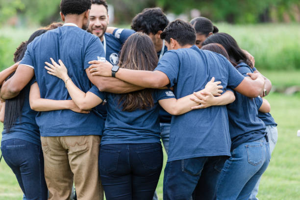 istock Multiracial team huddles with arms around each other 1500955847