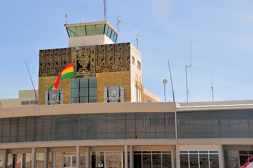 La Paz, Bolivia: La Paz El Alto International Airport - iconic Inca façade of the domestic terminal with control tower and Bolivian flag.