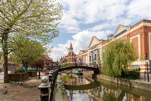 Lincoln, United Kingdom – May 07, 2023: The River Witham beside Waterside Shopping Centre in the city of Lincoln, UK and showing the Empowerment sculpture.