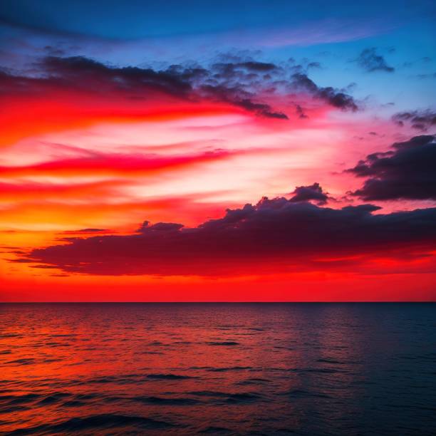 istock an orange, pink and blue sunset over the ocean with clouds 1500962898