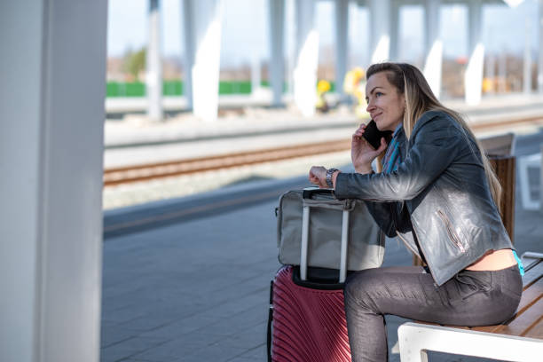 istock a woman is waiting for a train at the station 1500963210