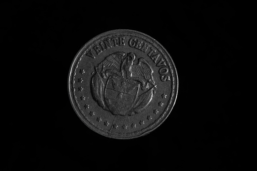 1940 silver Mercury dime close-up on black background.
