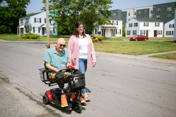 istock Social worker walking with disabled senior 1500965465