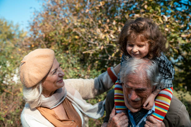 istock Carrying grandchild on a shoulders in long walk 1500971435