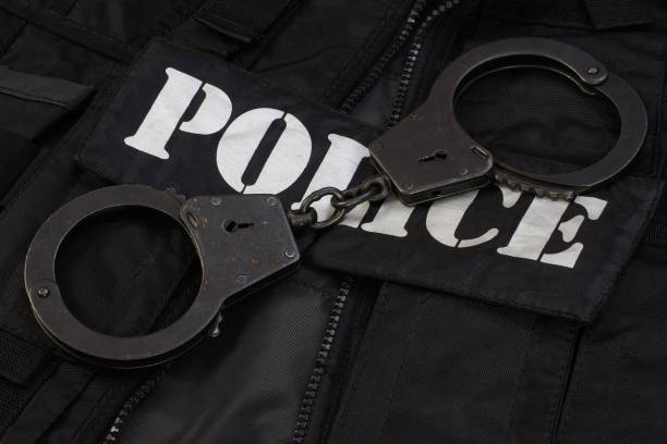 istock Police handcuffs on black uniform 1500983718