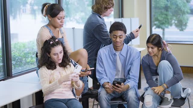 Group of multiracial teenagers with mobile phones