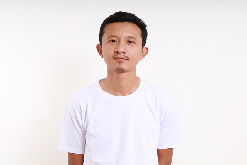 Asian funny man standing against white background