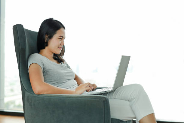 istock Beautiful asian woman using laptop computer working online at home. 1500986811