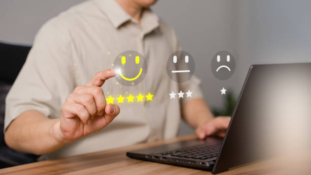 istock Shopper hand touching the virtual screen on the happy smile face icon for assessment feedback review satisfaction opinion and testimonial. Customer service experience and business satisfaction survey. 1500989088