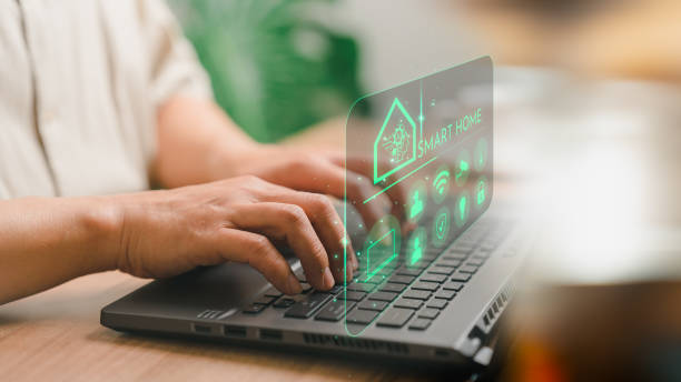 istock Adult man controlling technology AI smart home devices using a laptop computer with launched application in the bed room. Iot smart home automation app concept. 1500989323