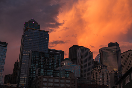 Seattle, USA - May 15, 2023: Late in the day a vivid sunset over pier 56 and the city.
