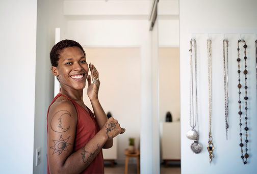 African American transgender woman doing skincare