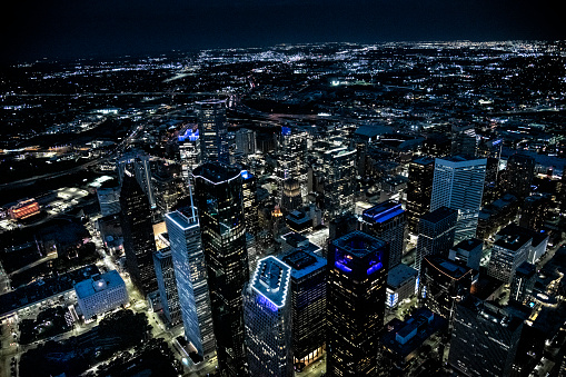 The illuminated streets and buildings of downtown Houston, Texas on an early spring evening just after sunset shot from an altitude of about 1200 feet directly over the city.
