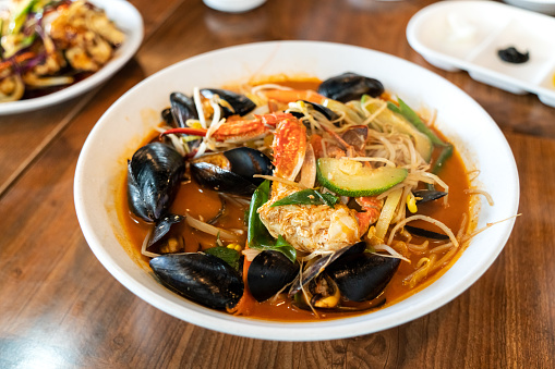 Delicious jjamppong, jjambbong, Chinese-style Korean noodle soup topped with red, spicy seafood and kimchi broth in South Korea.