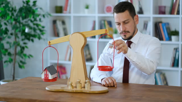 businessman working on budget balance on equal-arm scales