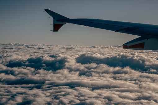 Plane wing with clouds